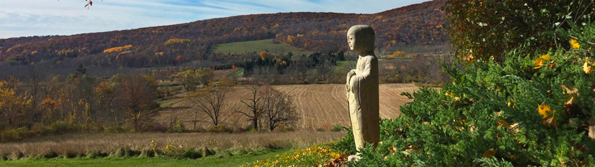 Jizo statue overlooking mountains near Ancestral Heart Temple